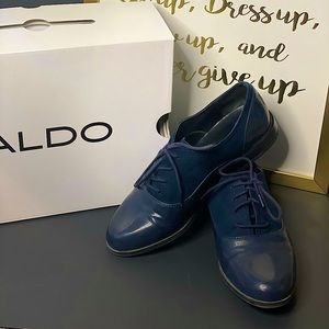 Navy blue patent leather and suede tie up loafer